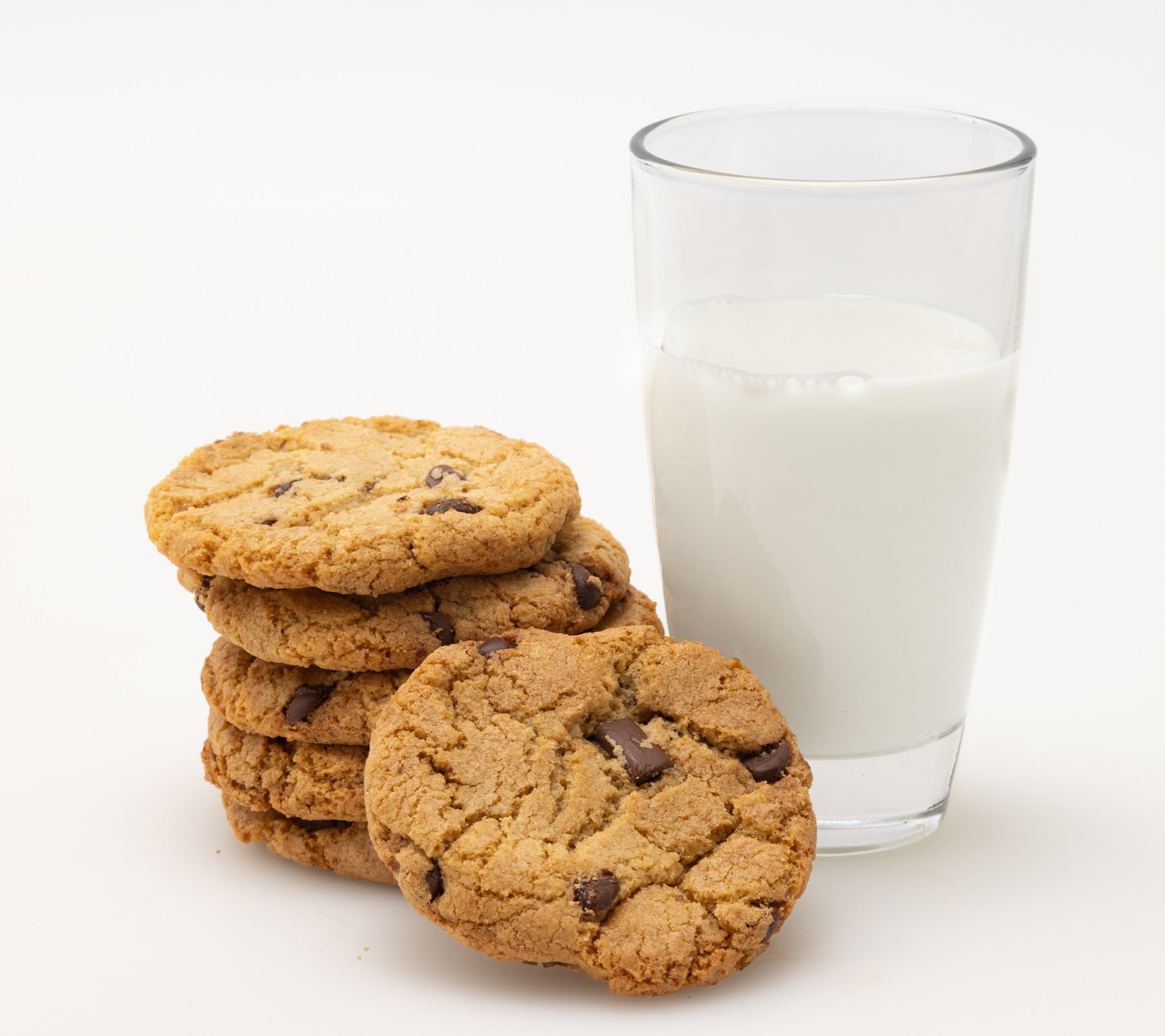 Glass of milk with stack of chocolate chip cookies