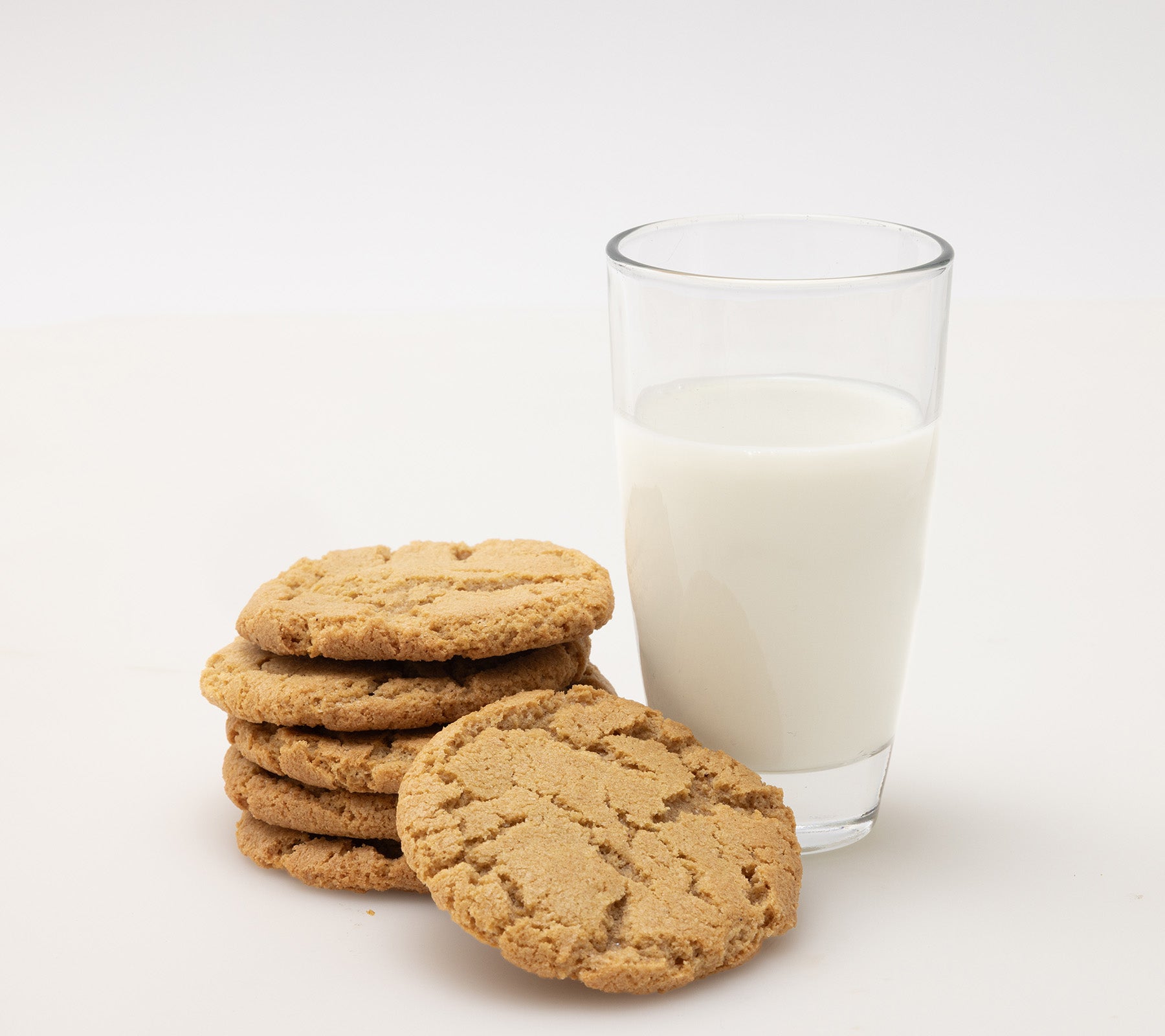 six einkorn cookies with glass of milk