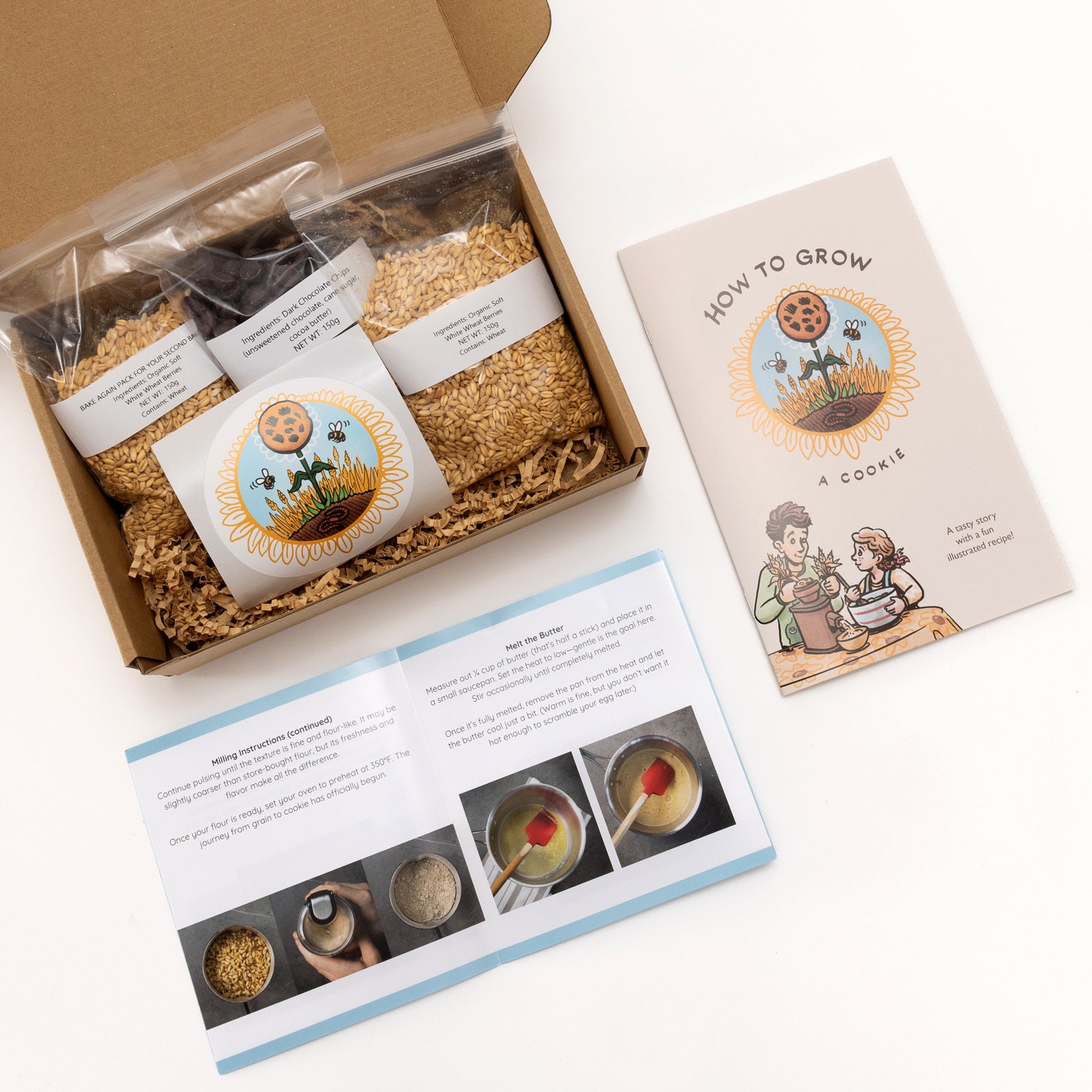 Open cardboard box containing ingredients for cookies with a recipe card on a white background